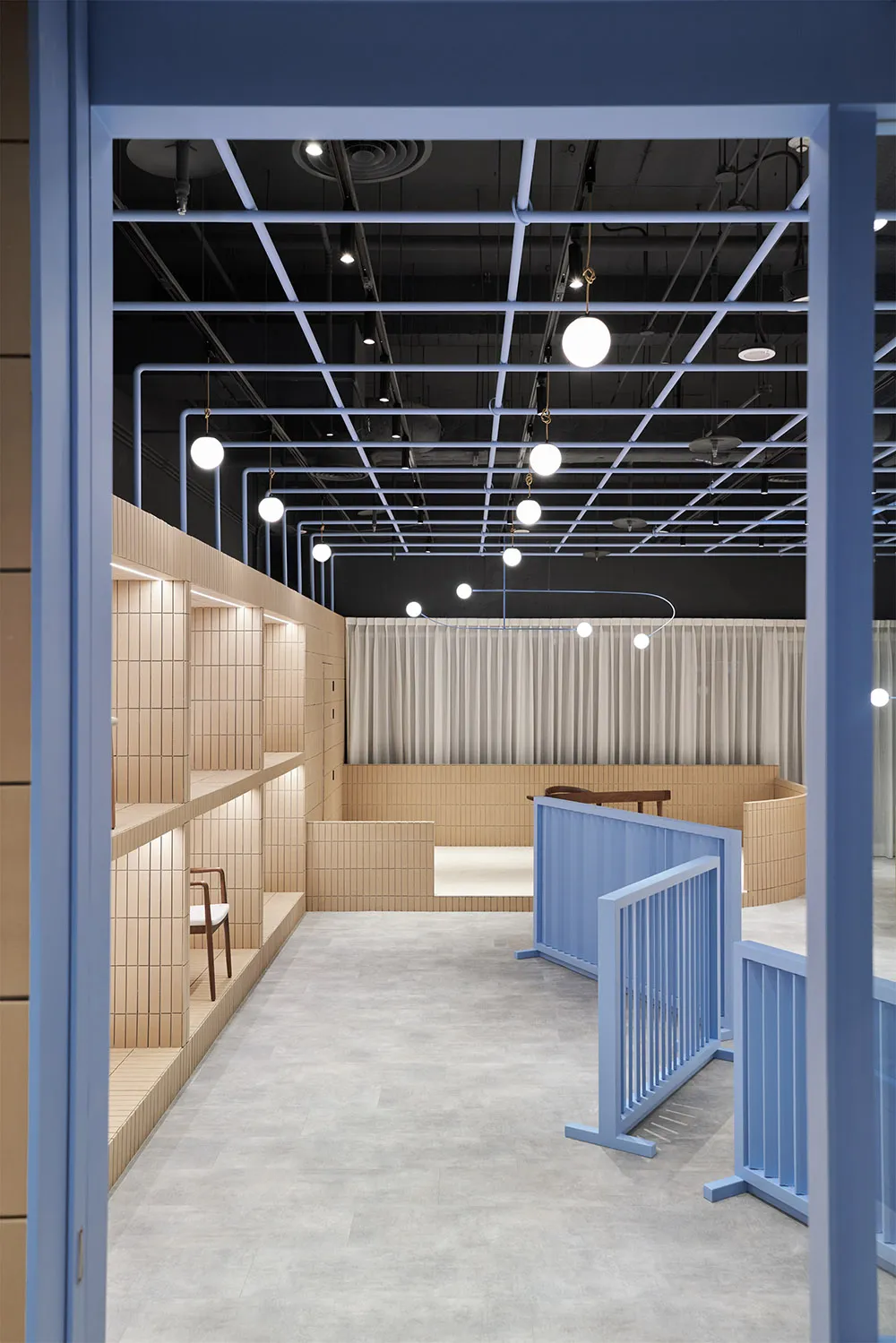 A modern retail storefront featuring a minimalist design with wood tiles on the walls and floor.