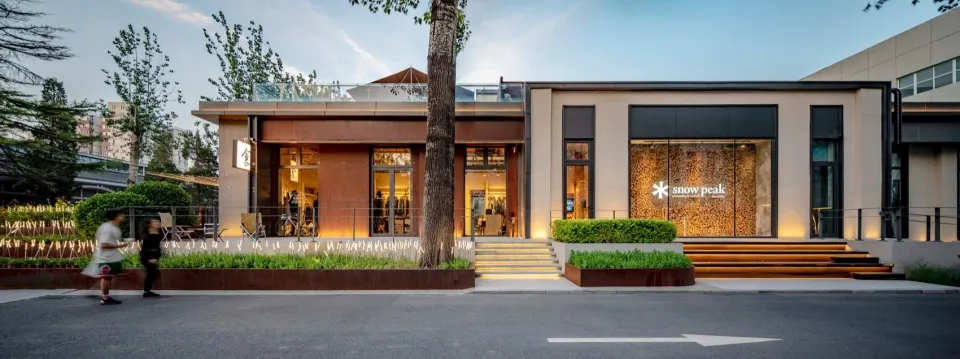 Modern retail storefront with wood, glass, and metal materials.