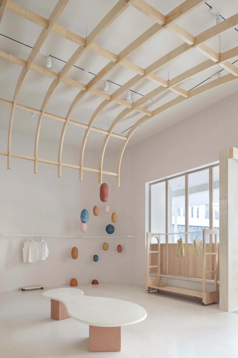 A minimalist retail space featuring concrete flooring and wooden accents.