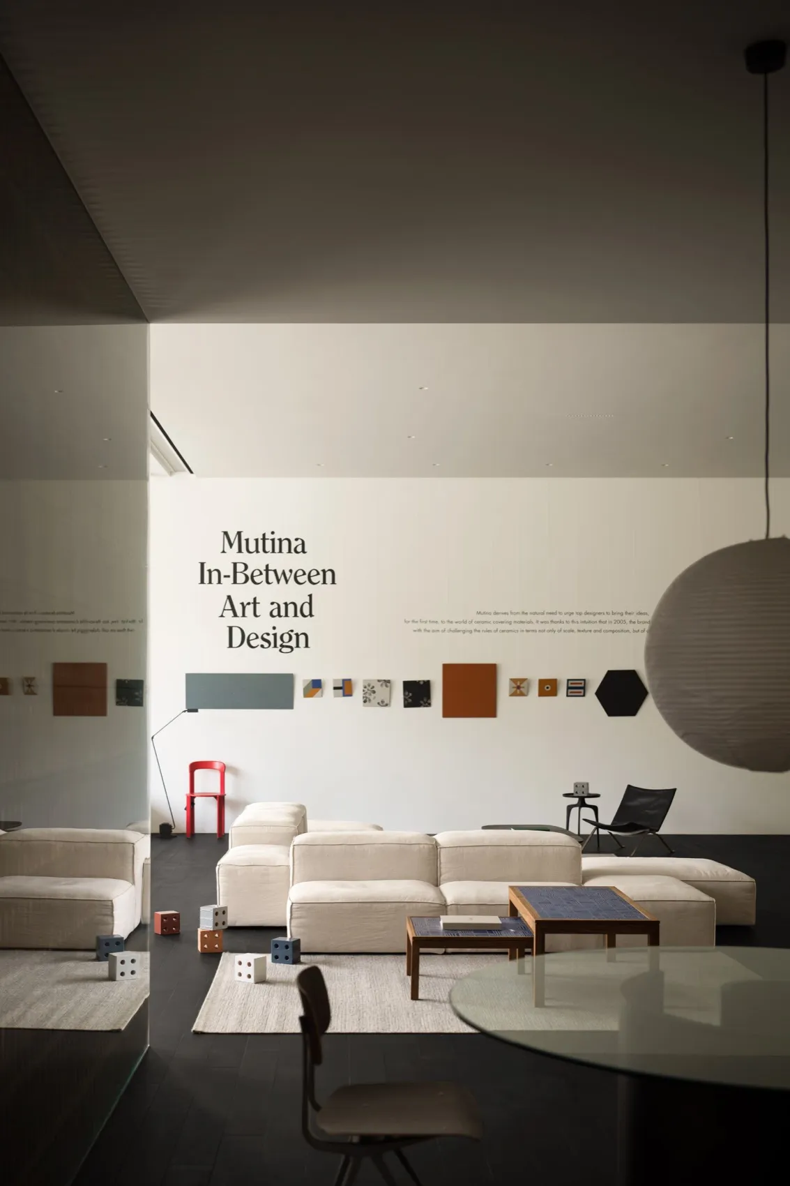 Minimalist living room with fabric seating, modern art, and sleek furniture.