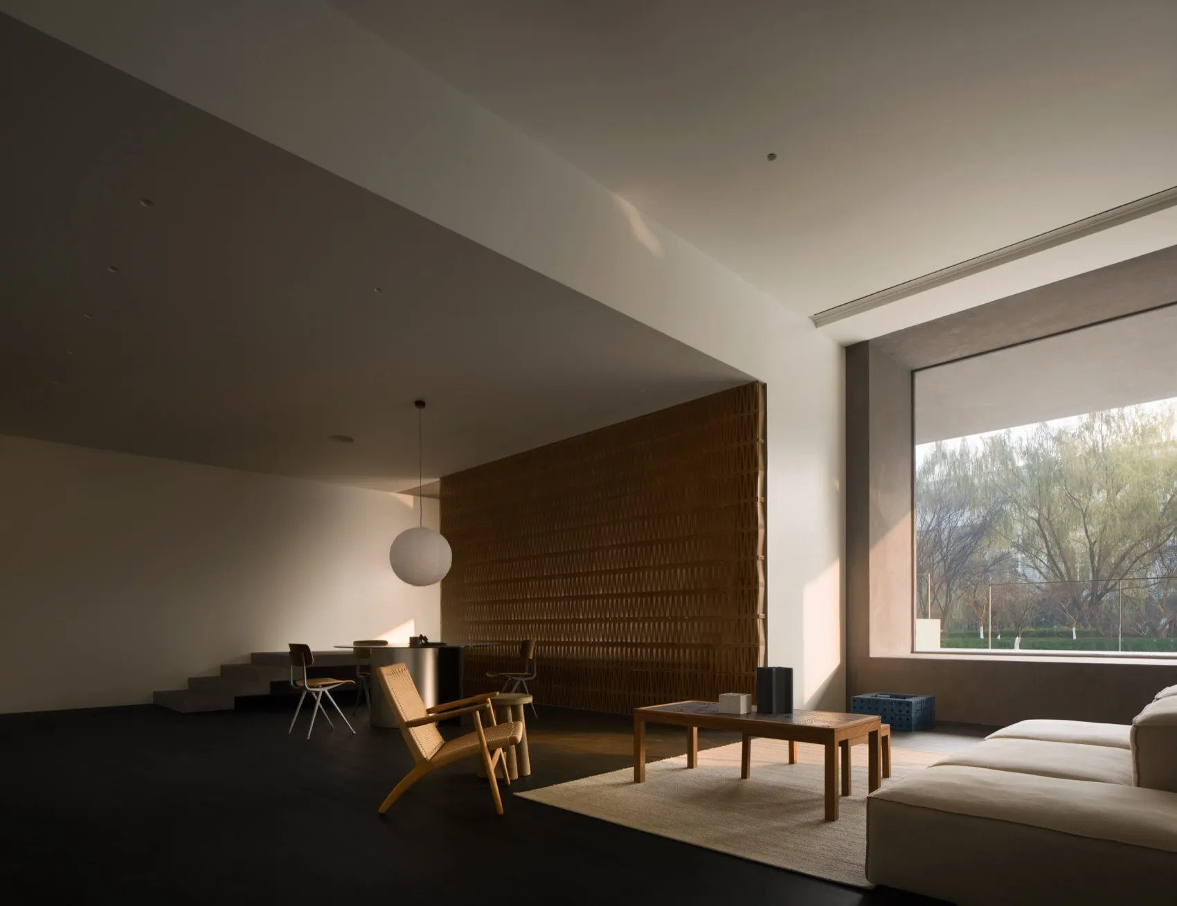 Modern minimalist living room featuring wooden elements and natural light.