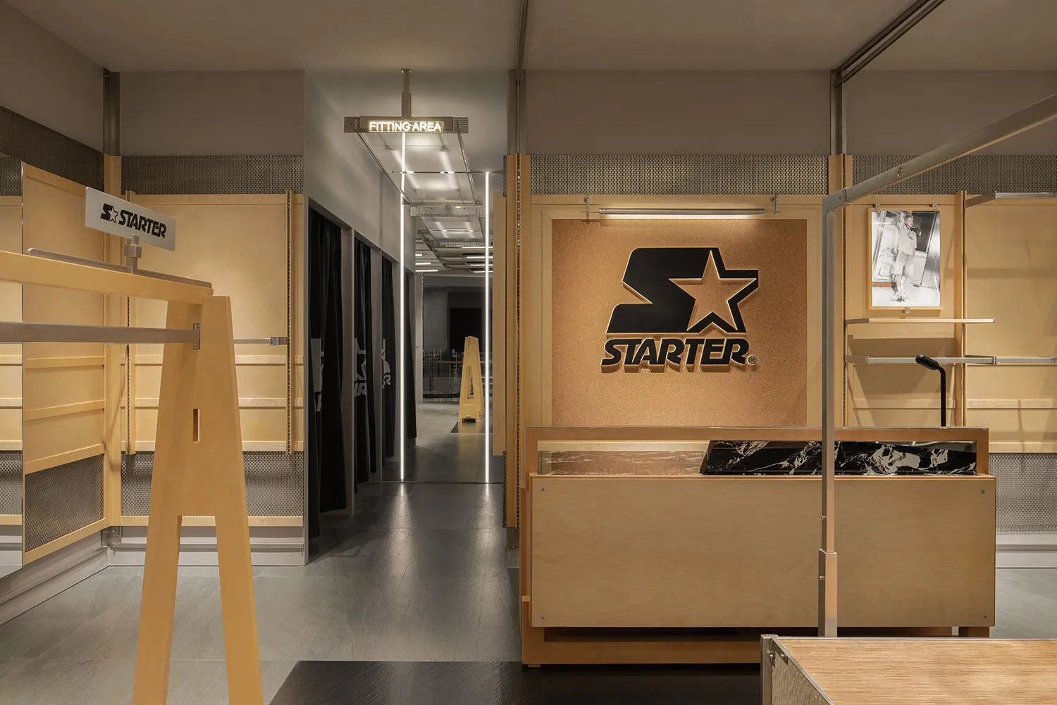 A retail clothing shop featuring wooden interiors and fixtures.