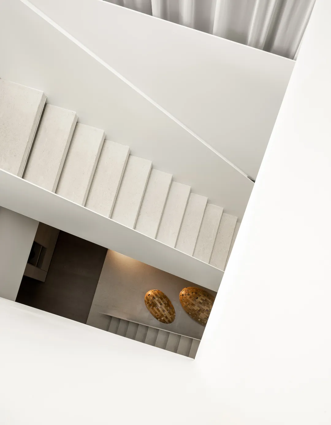 Concrete stairs with white walls and a wooden floor.