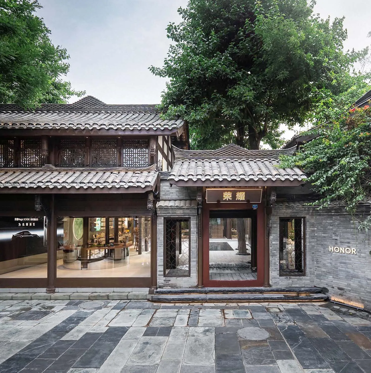 Traditional retail storefront featuring wooden structures, stone walls, and large glass windows.