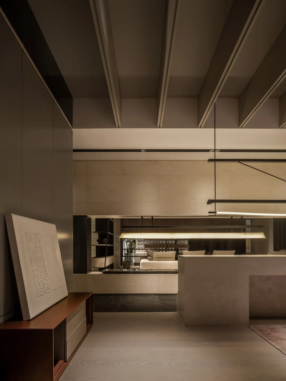 A spacious, minimalist modern living room with concrete accents.