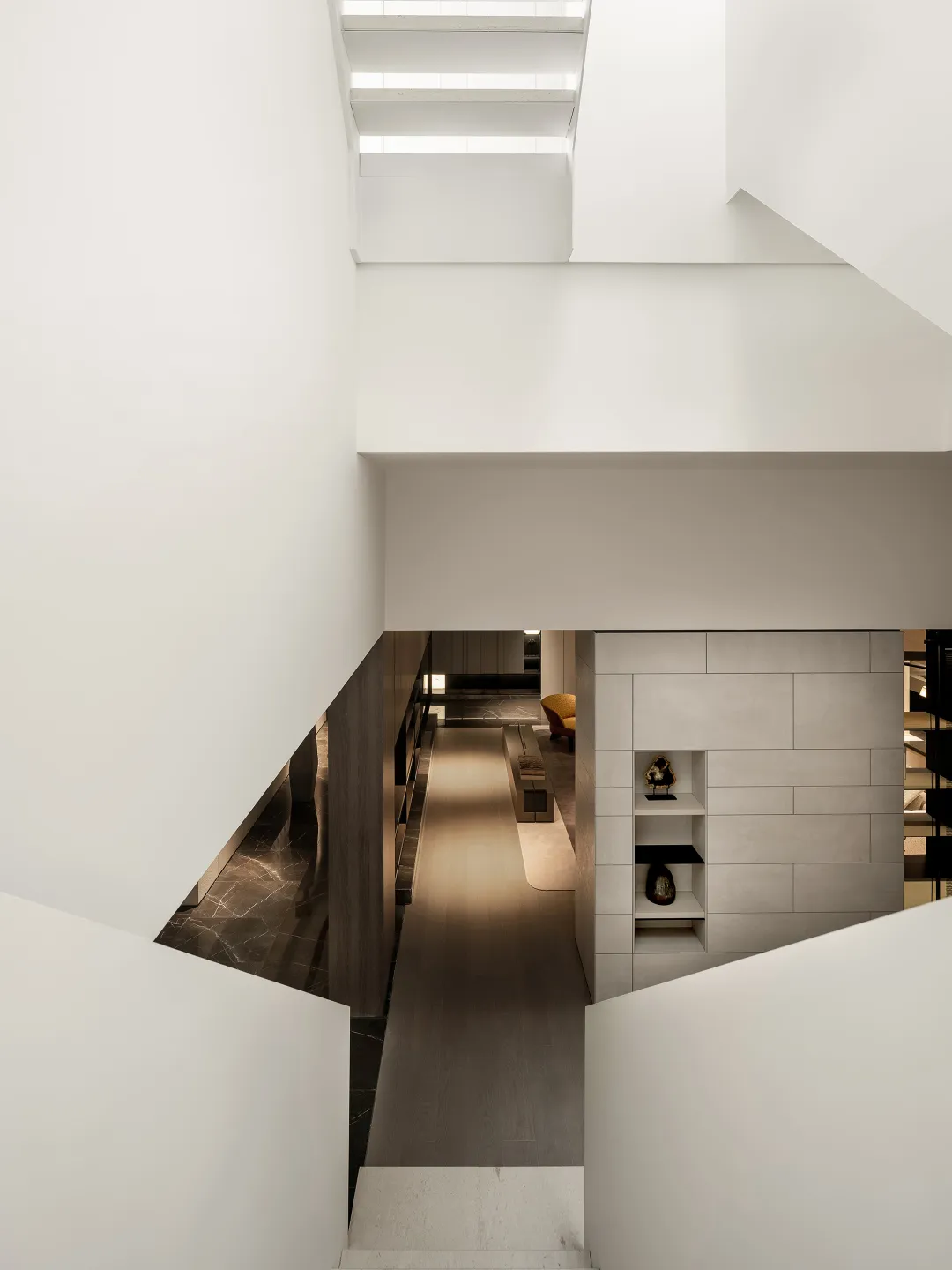 Modern residential interior featuring a sleek, minimalist staircase made of concrete.