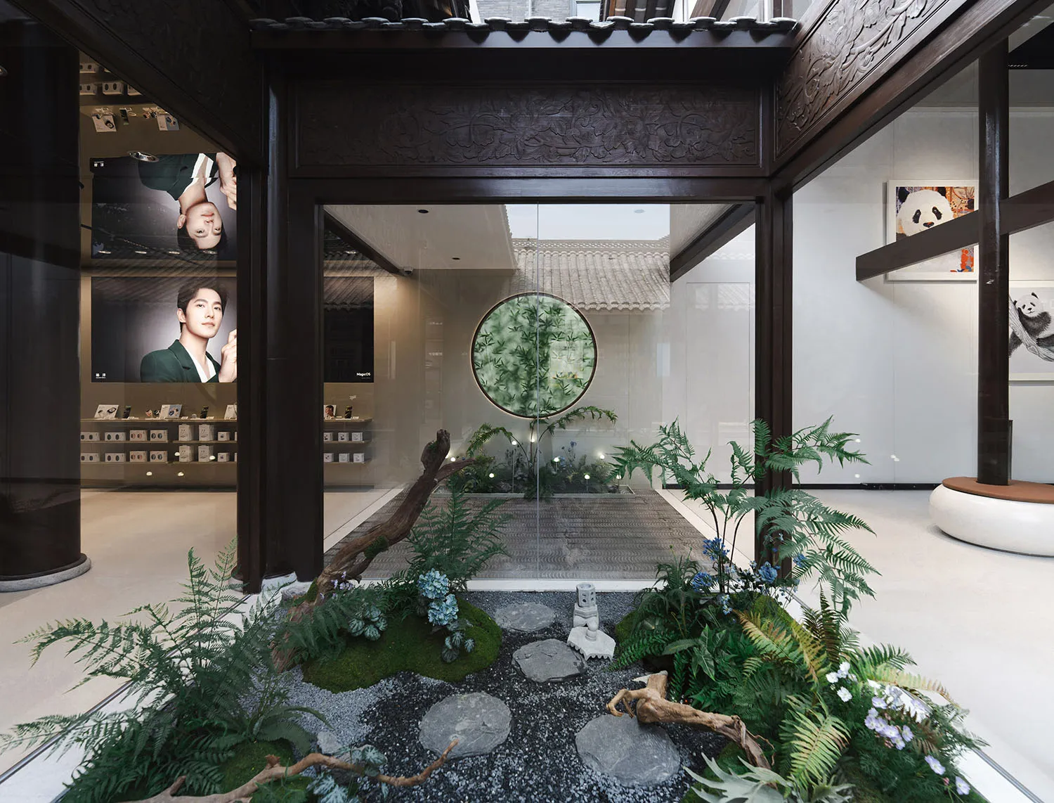 A modern storefront with an indoor garden featuring a wooden frame, glass walls, and a natural rock garden.