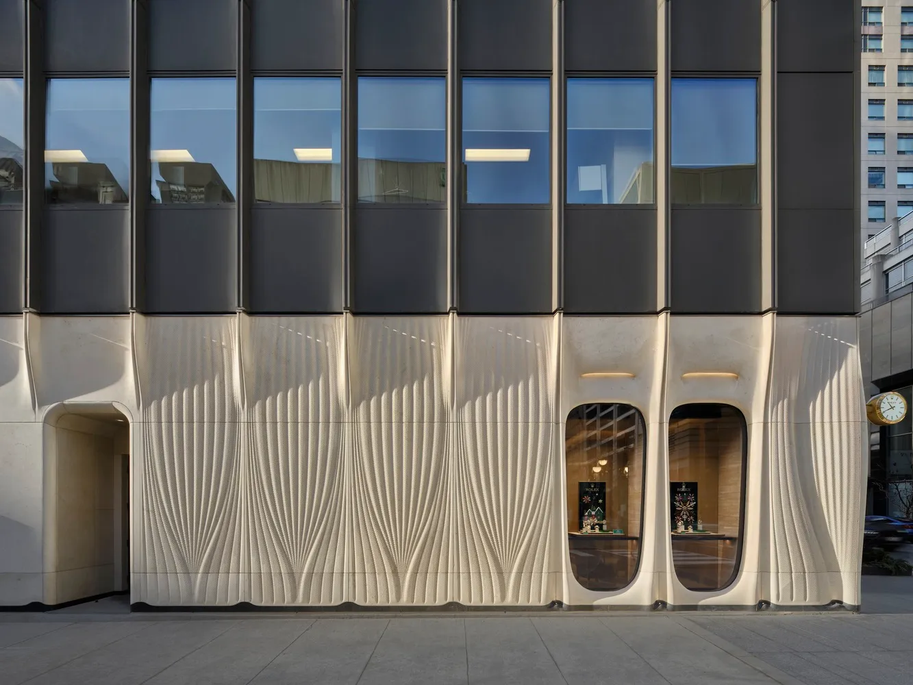 A modern building with a metallic cladding facade.