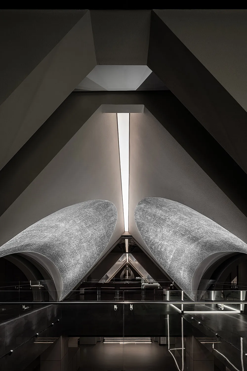 A modern interior space with concrete walls, featuring geometric shapes and a minimalist design.