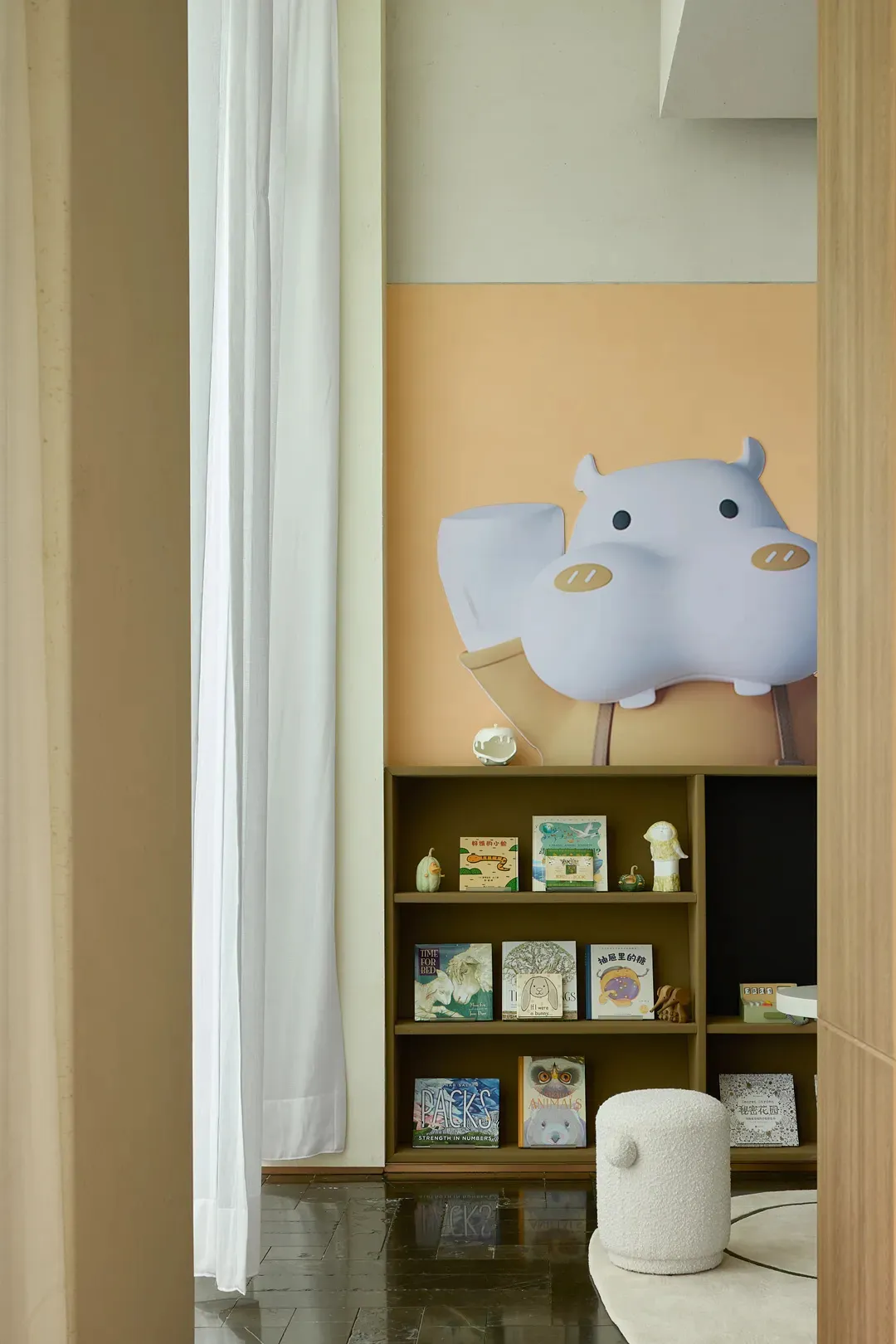 A modern children's room with an acrylic animal sculpture and wooden shelves.