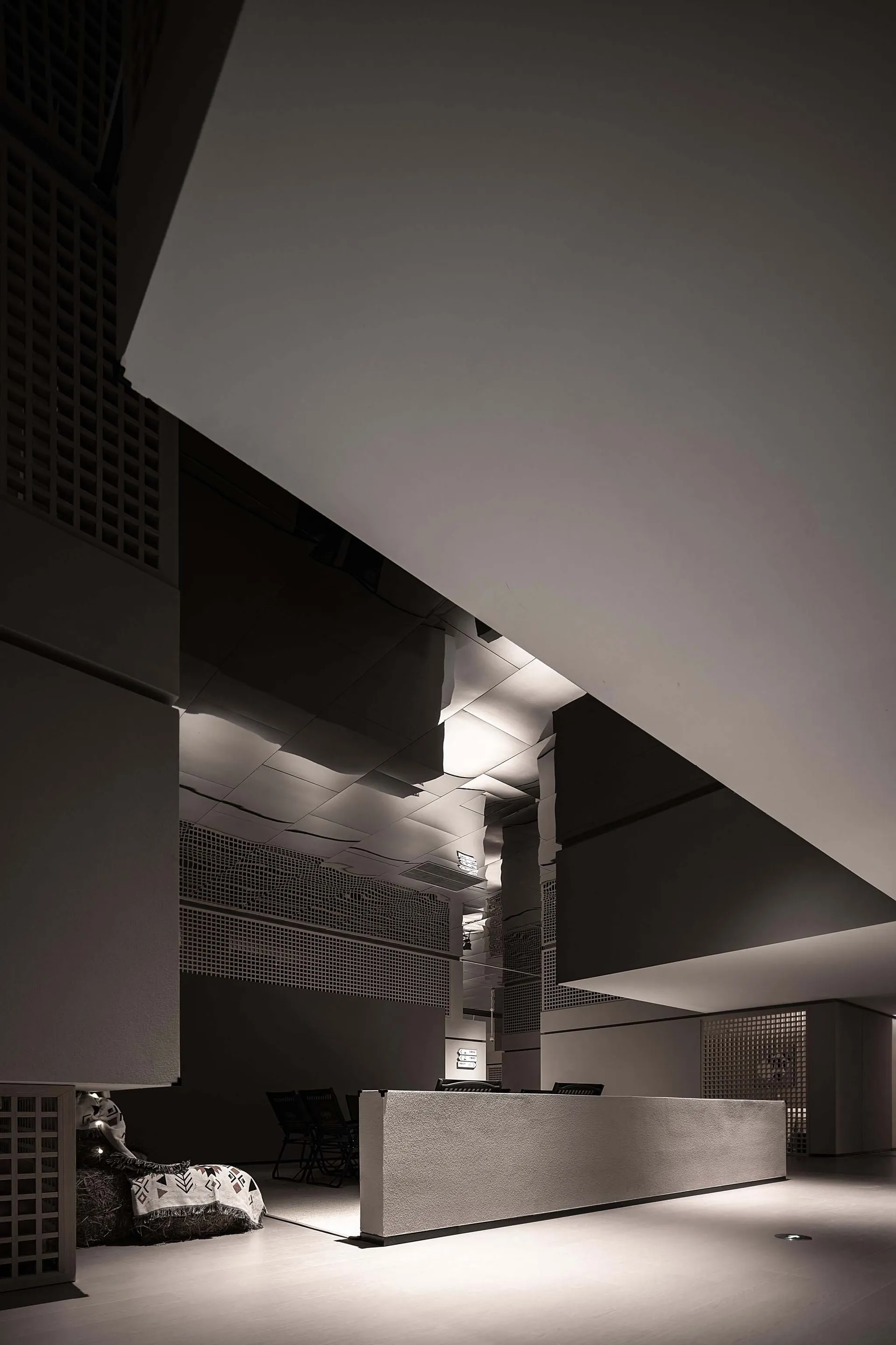 Modern industrial lobby featuring concrete walls and white walls.