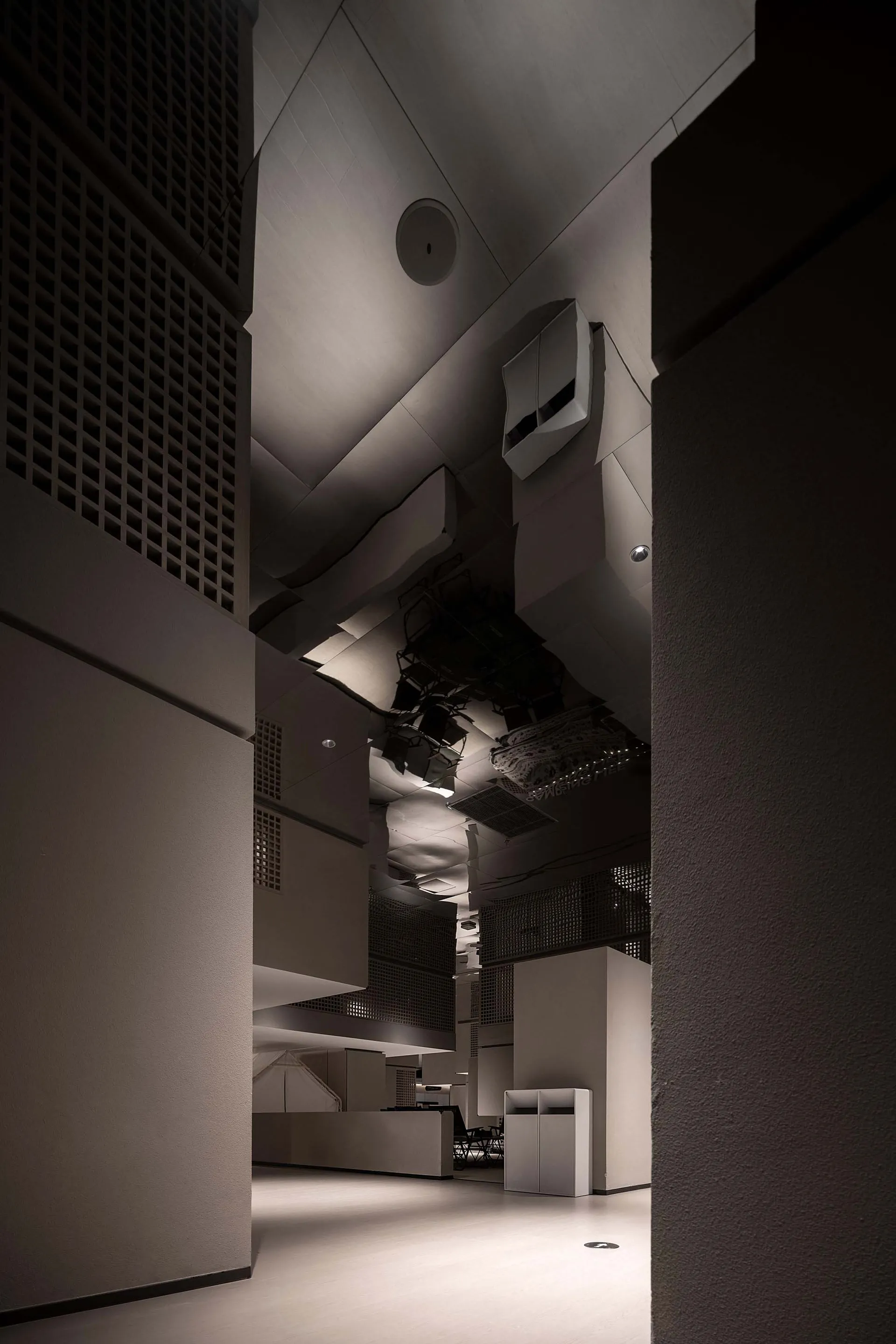 Modern office space featuring industrial, minimalist design with concrete walls and floor.
