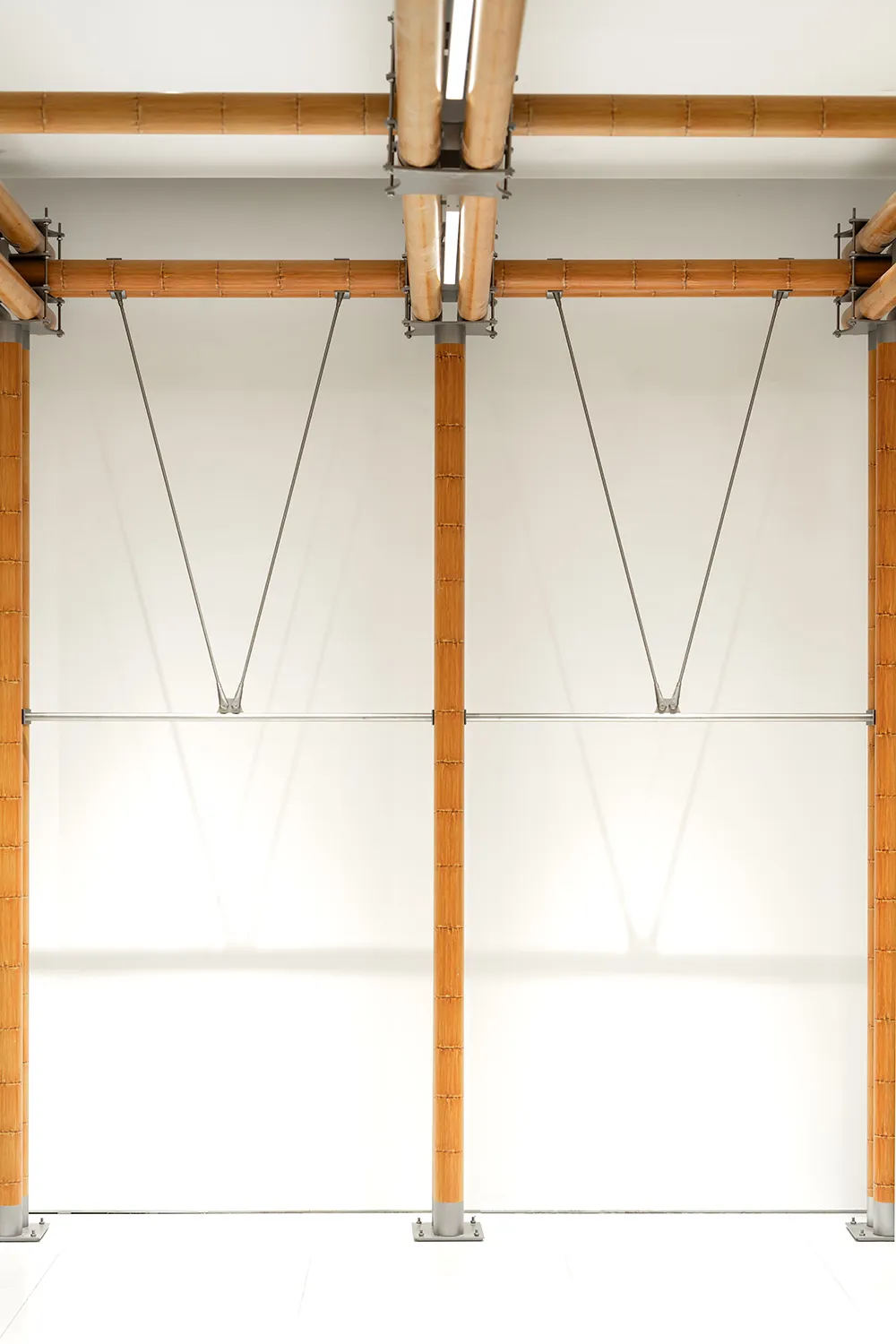 A modern interior design featuring wooden structural elements and lighting.