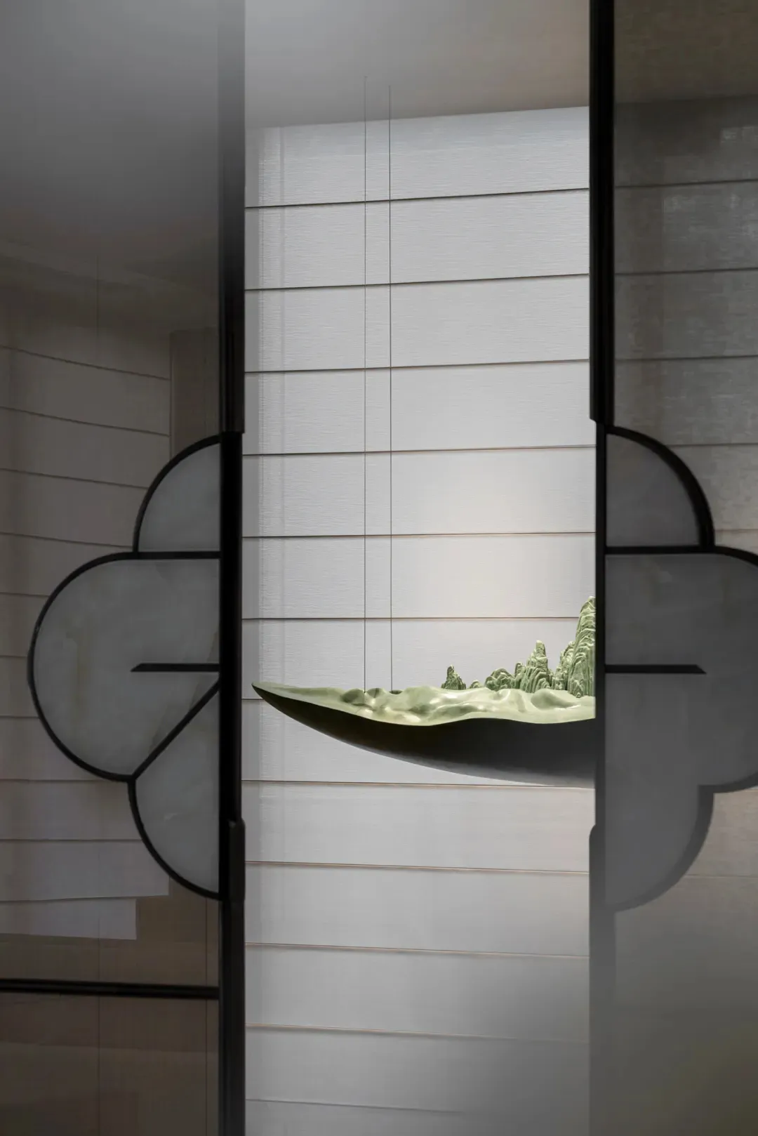 Ceramic wall art featuring mountain landscape displayed on a white wall with horizontal lines.