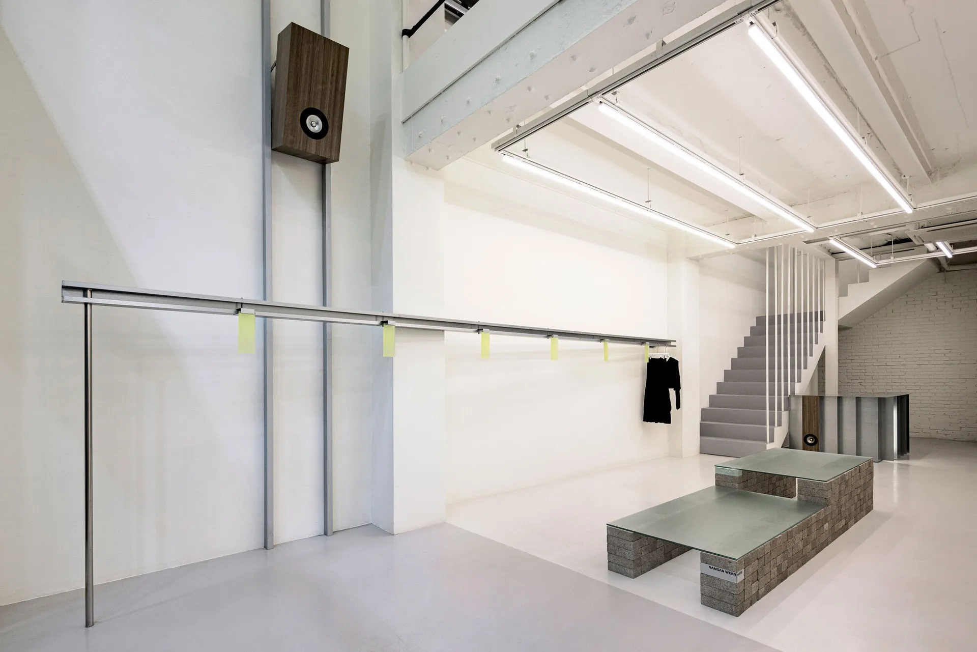A minimalist commercial space featuring a metallic architectural design element.