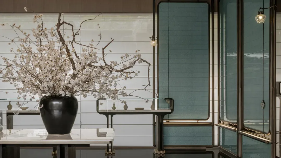 A minimalist living room featuring glass walls and sleek modern furnishings.