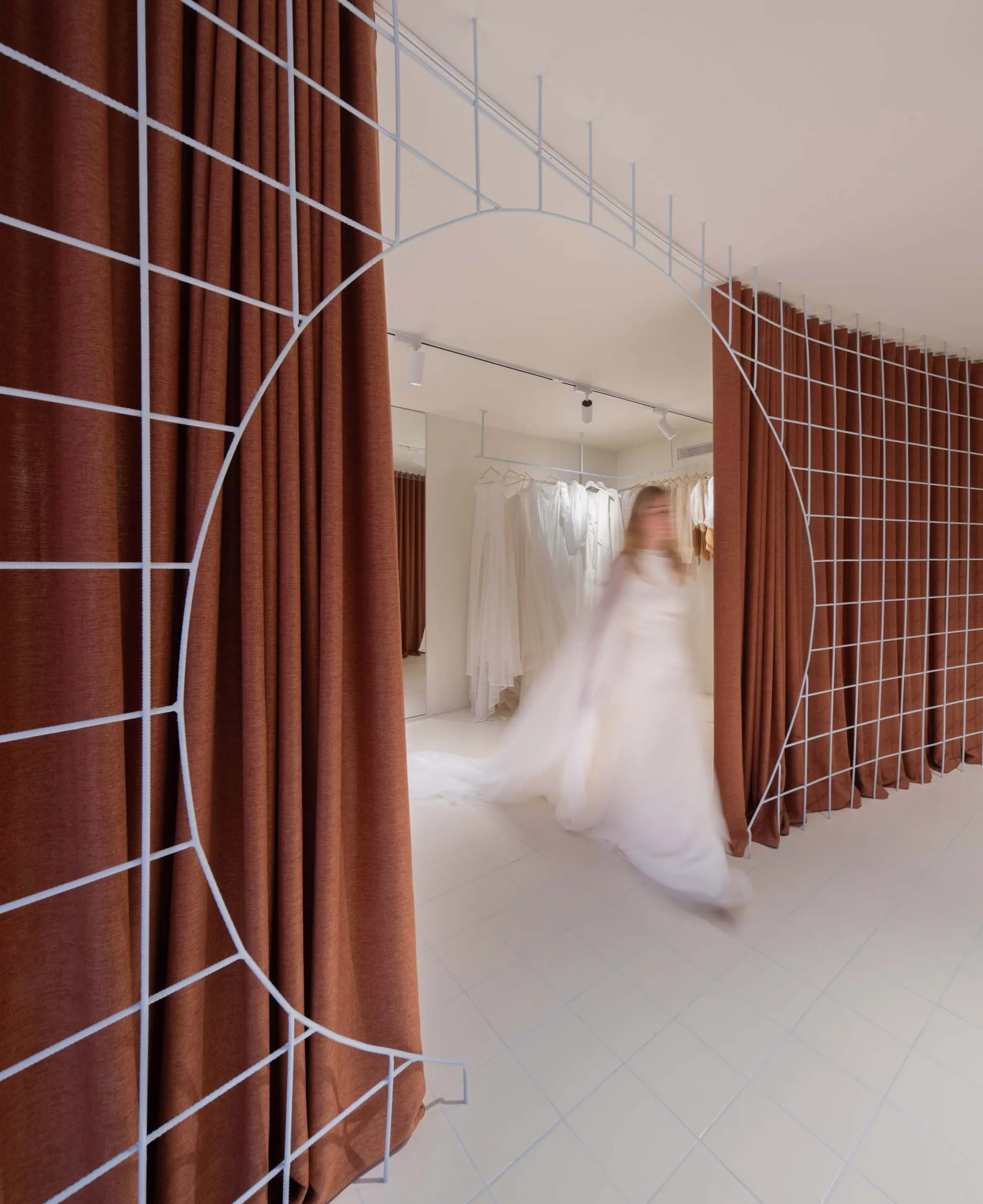 A modern clothing retail shop featuring metal structures and fabric walls