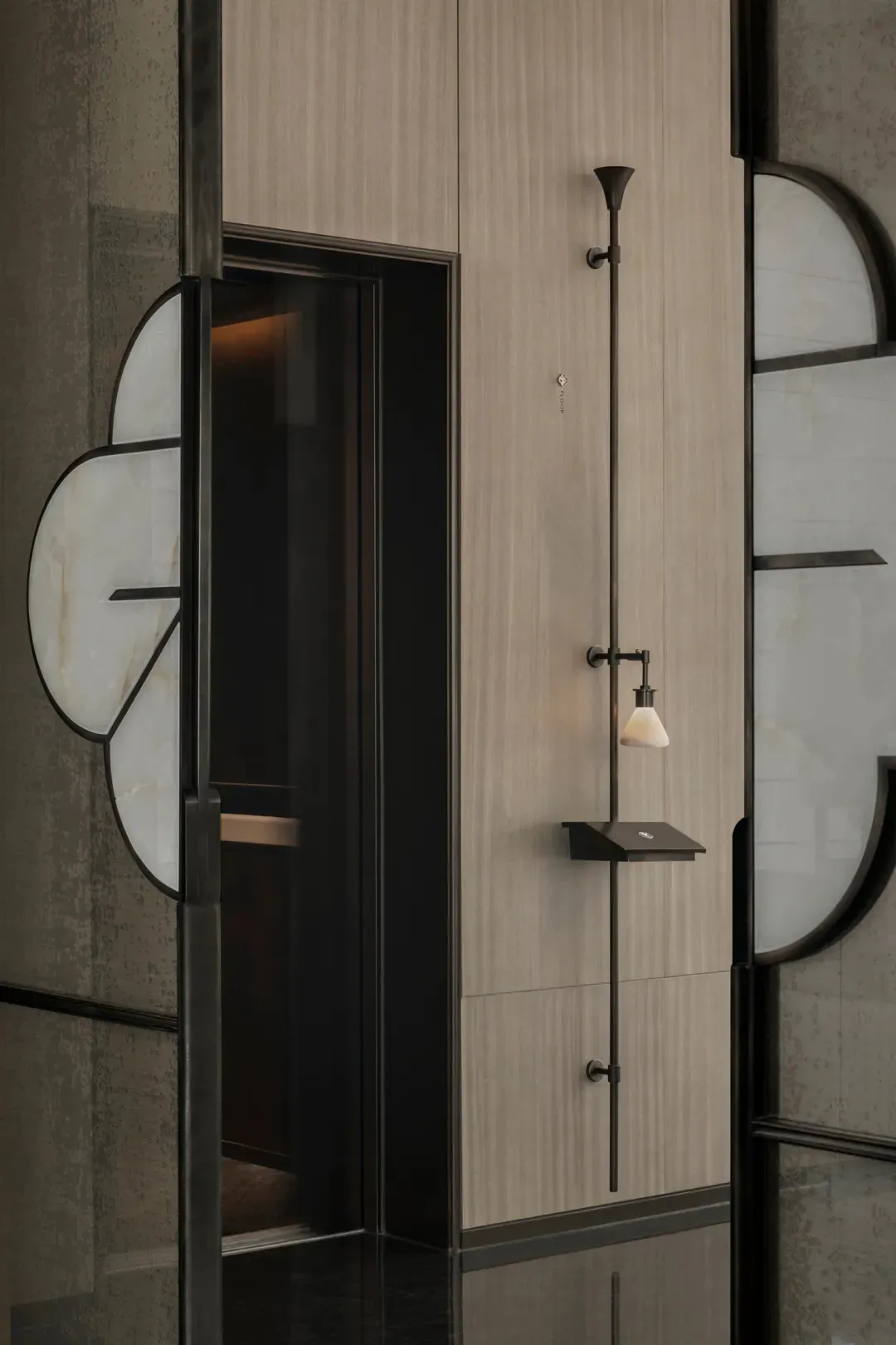 A modern entryway featuring glass and metal materials with a minimalist design aesthetic.