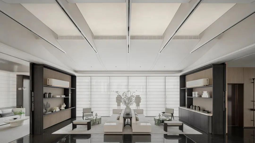 Contemporary office lounge featuring minimalist design with sleek, white furnishings on a polished black floor.