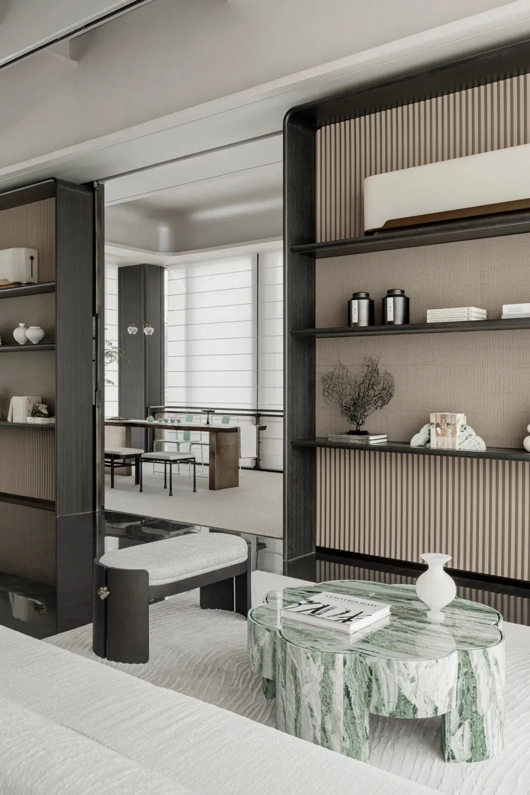 A modern residential interior featuring a marble coffee table, contemporary furniture, and minimalist decor.