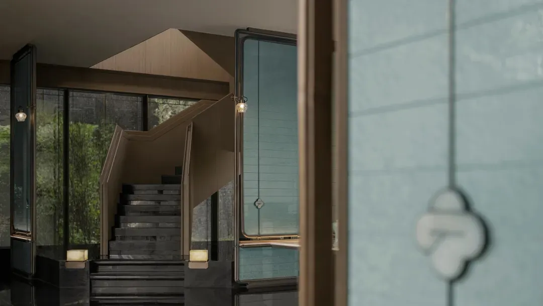 Modern staircase with concrete steps and a glass panel wall.