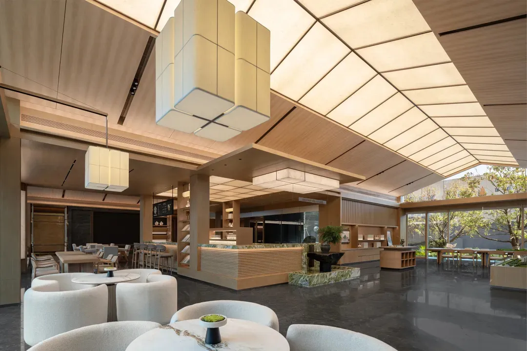 Modern coworking space featuring marble, wood, and glass materials and minimalist design
