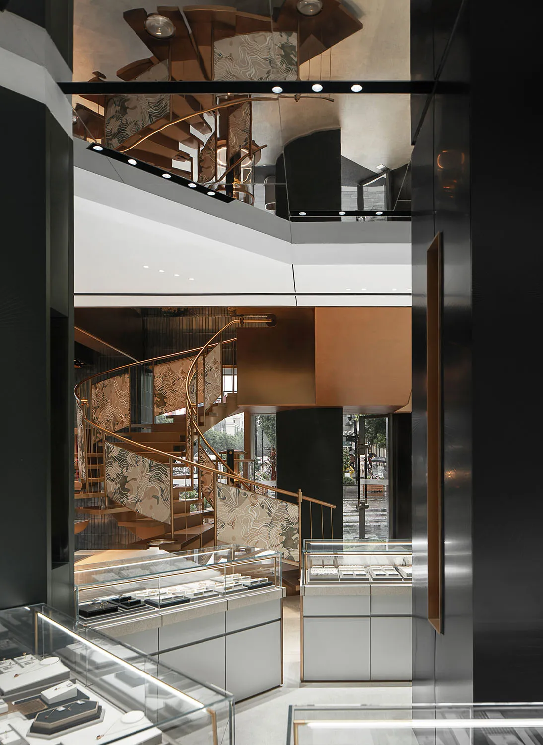 A modern jewelry shop featuring metallic and glass decor, with a focus on the elegant display cases and the stylish interior
