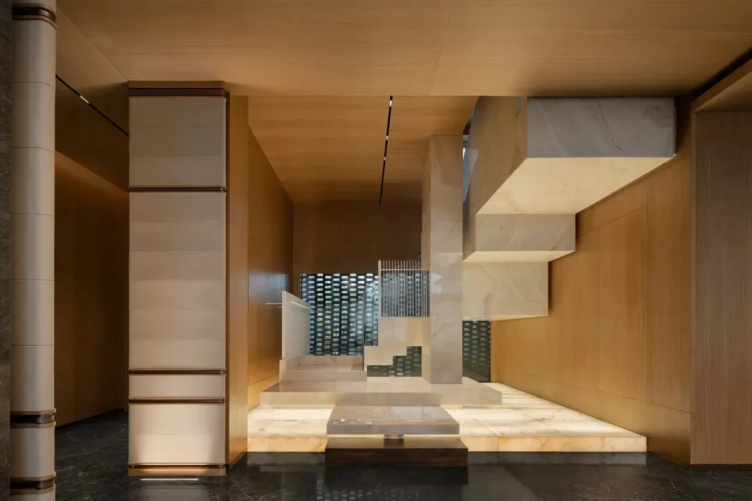 Modern lounge area with marble floor and walls, showcasing contemporary design elements.