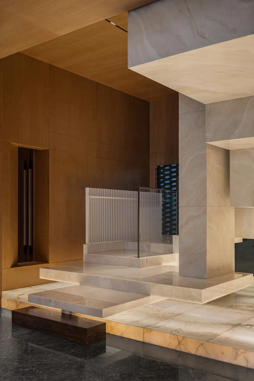 A modern lobby featuring marble elements and architectural design details.