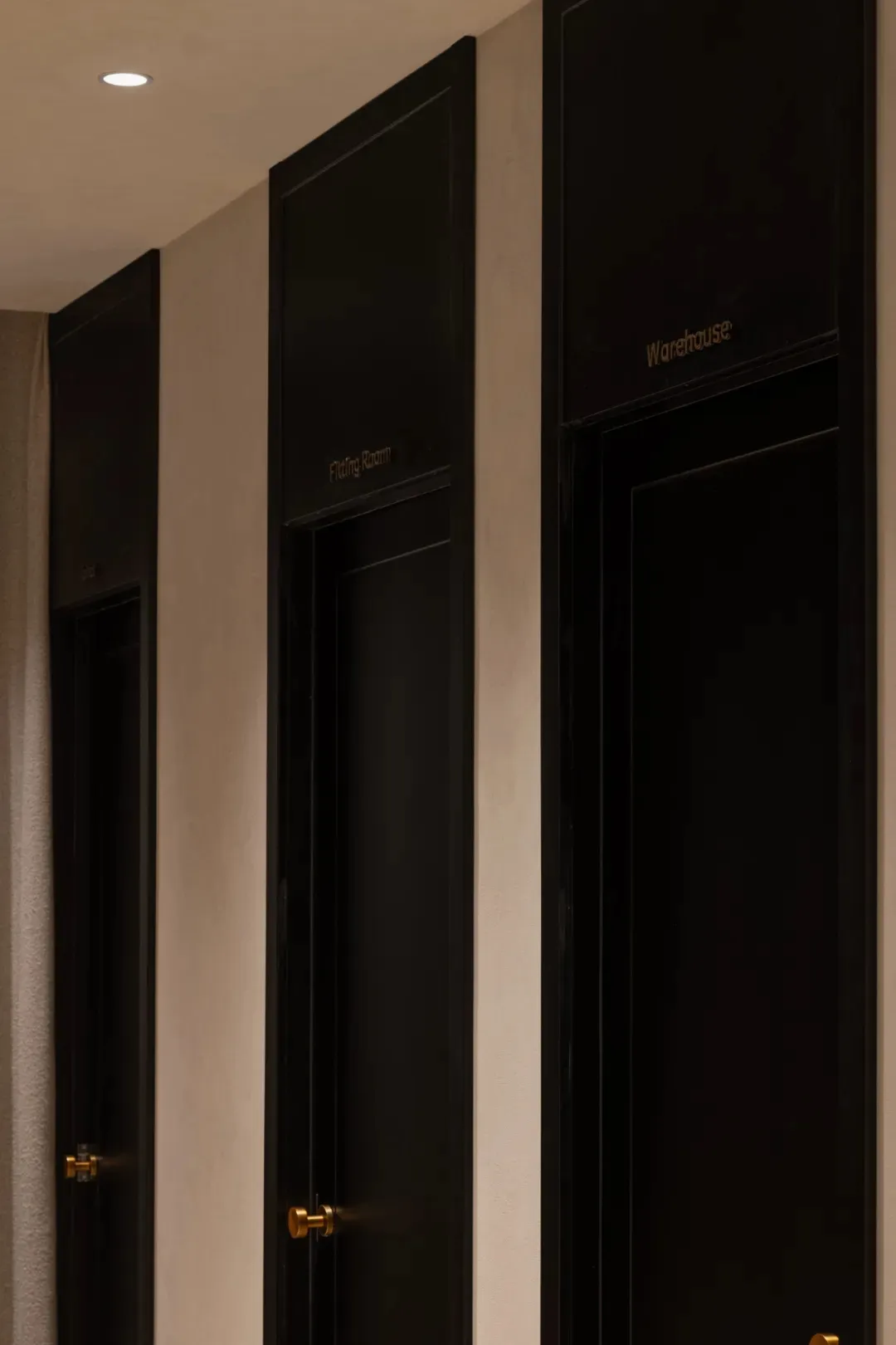 Black fitting room door in a modern fashion retail environment