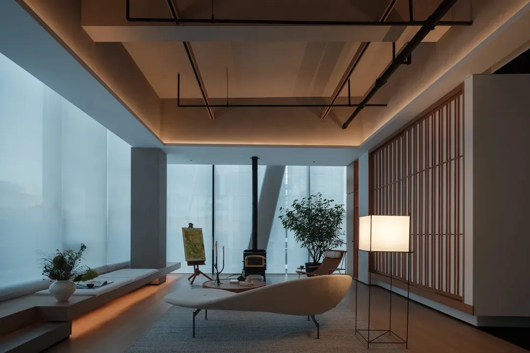 Modern living room featuring natural light, wooden elements, and minimalist furniture