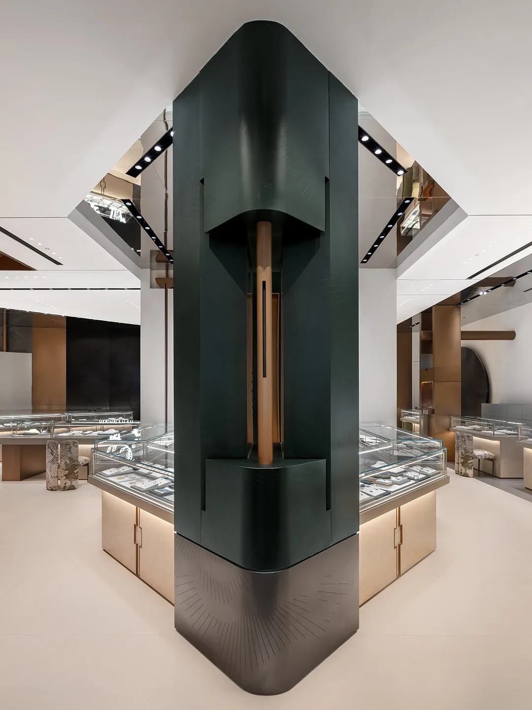 A modern retail jewelry shop featuring a prominent black cylindrical column.