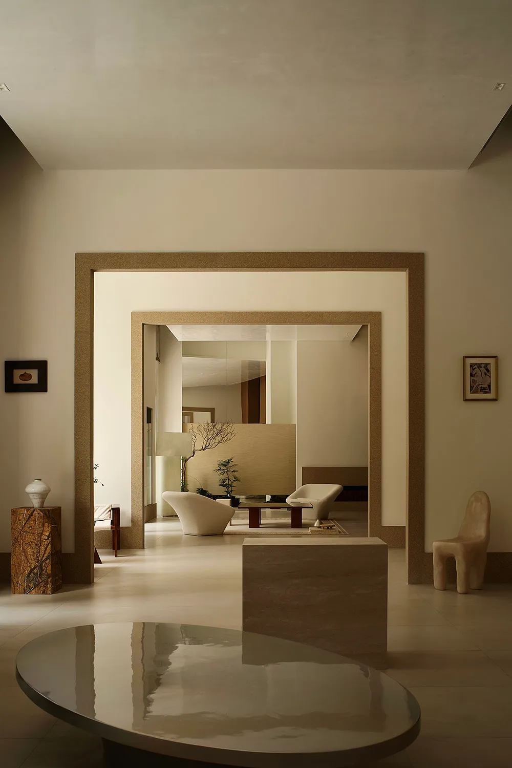 A minimalist living room with stone furniture and a large, open space.