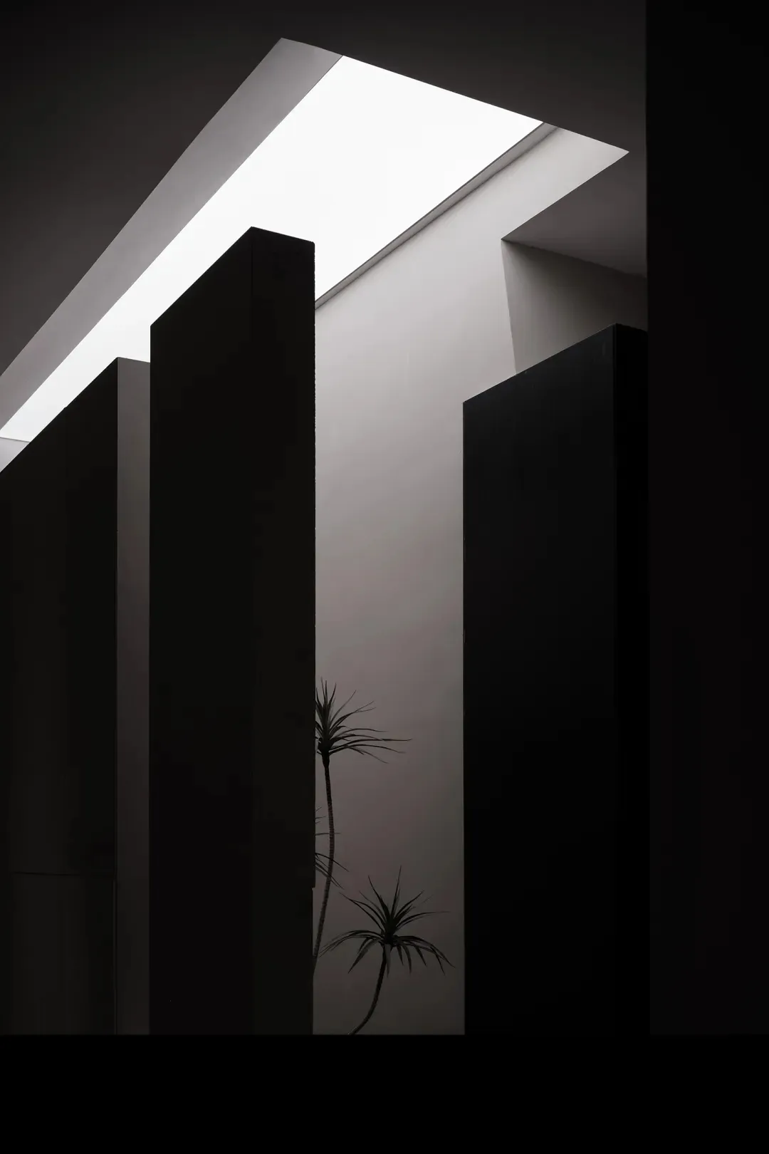 A minimalist interior design featuring modern concrete and glass materials.