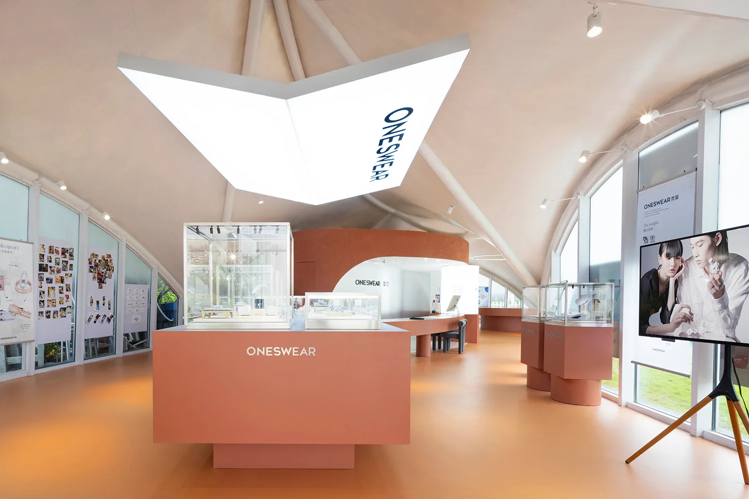 Minimalist modern retail storefront with glass walls and interior design elements.