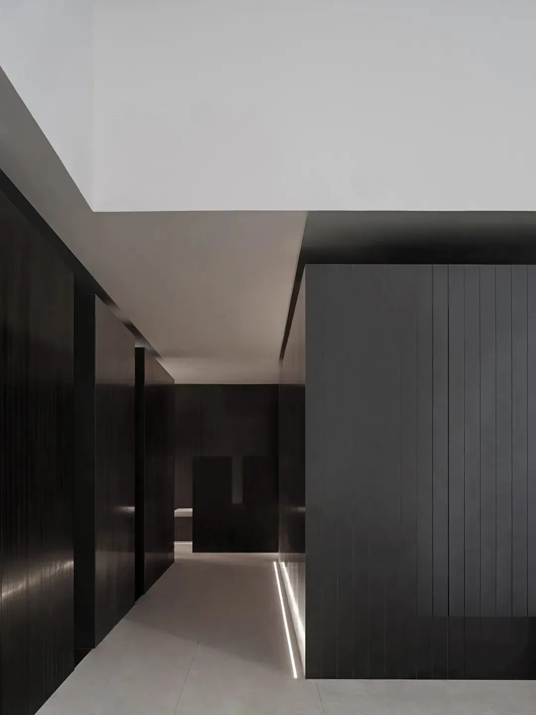 Black and white minimalist office with concrete flooring and walls.