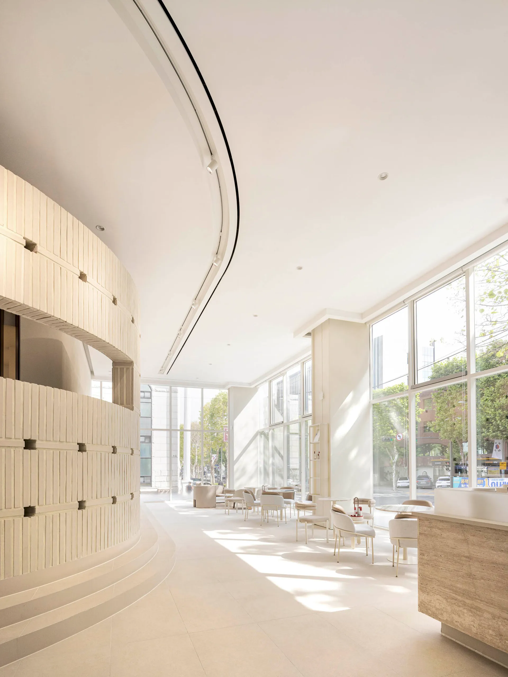 Modern, minimalist commercial interior with large windows showcasing a sleek, contemporary design.