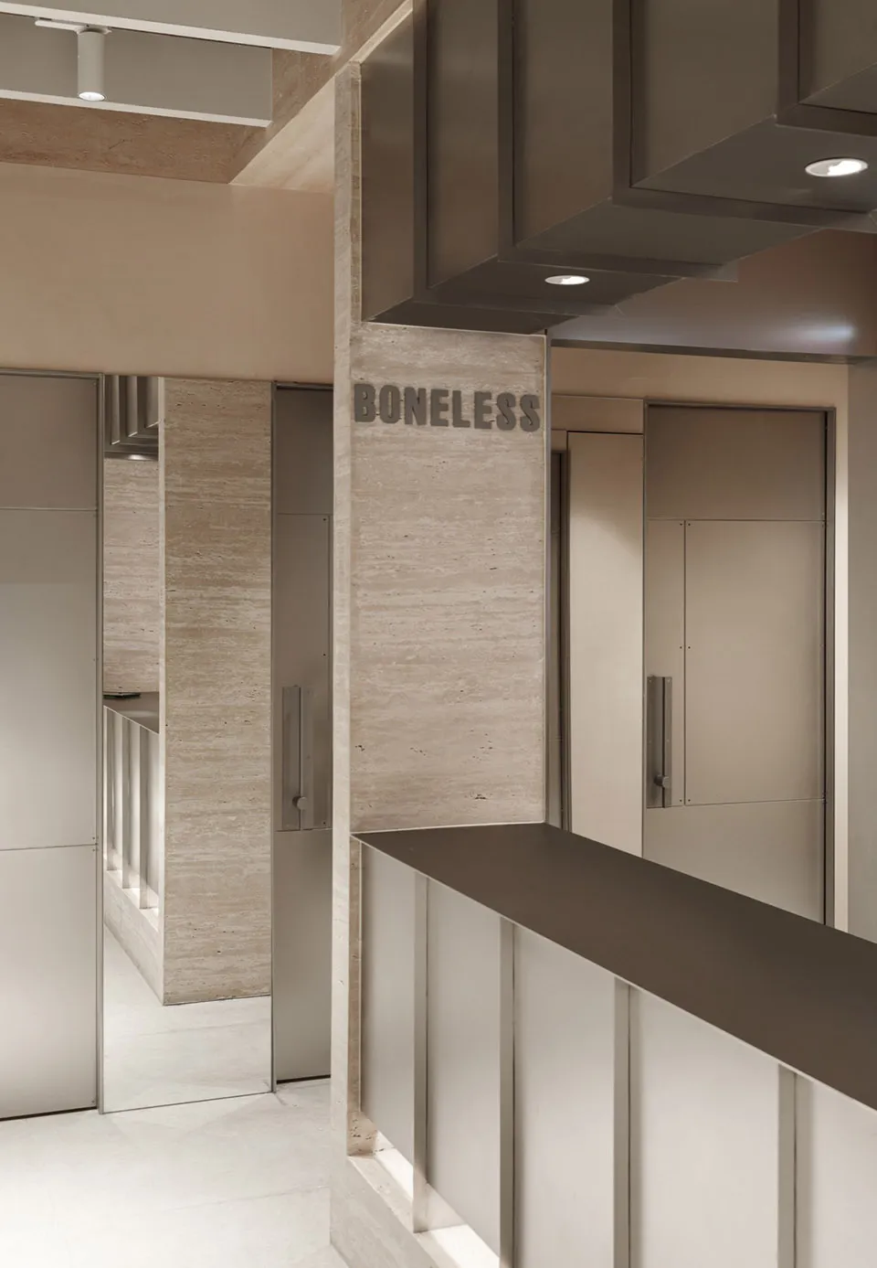 Interior view of a modern restaurant featuring concrete walls and flooring.