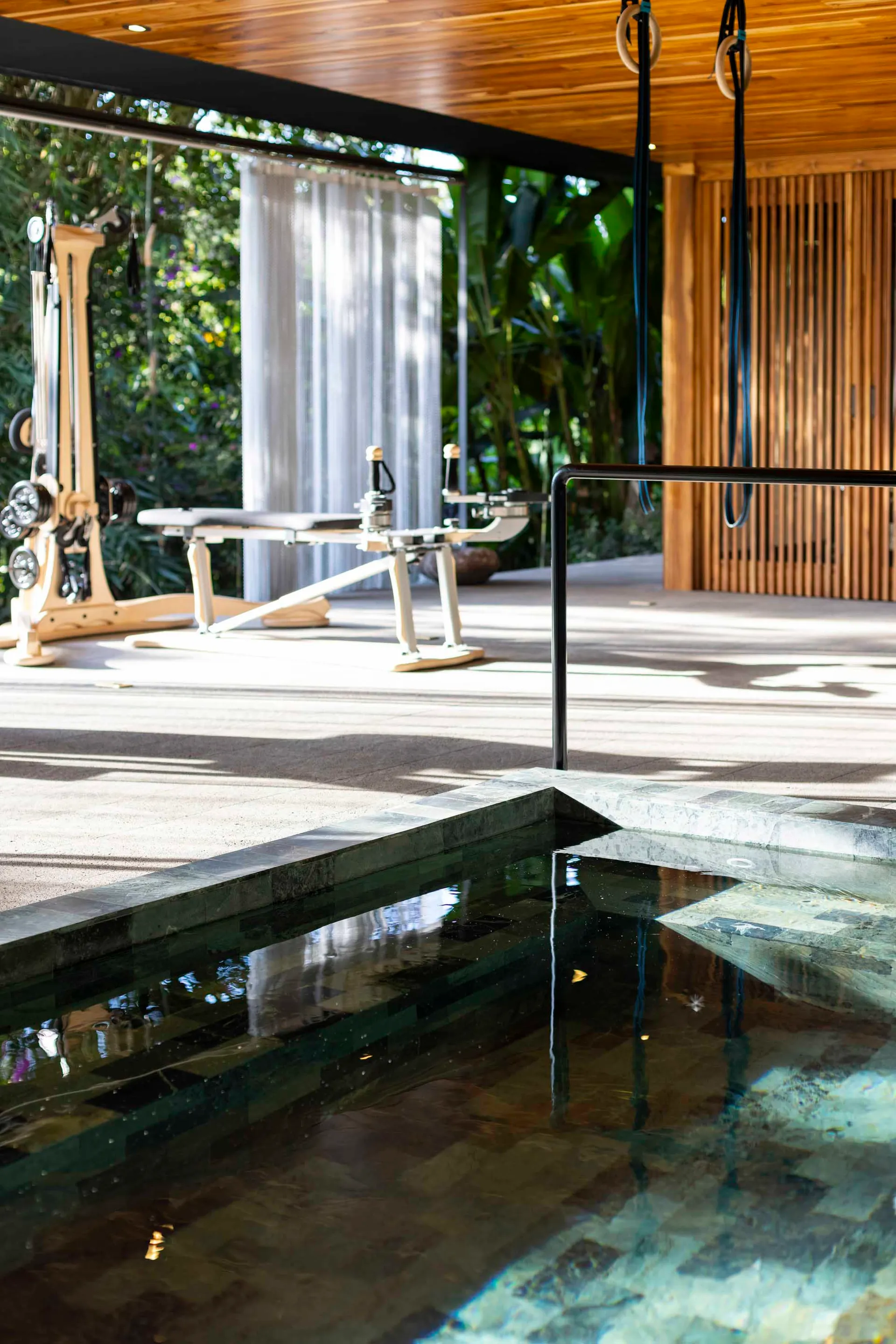 An elegant minimalist spa facility featuring wooden elements and a serene environment.