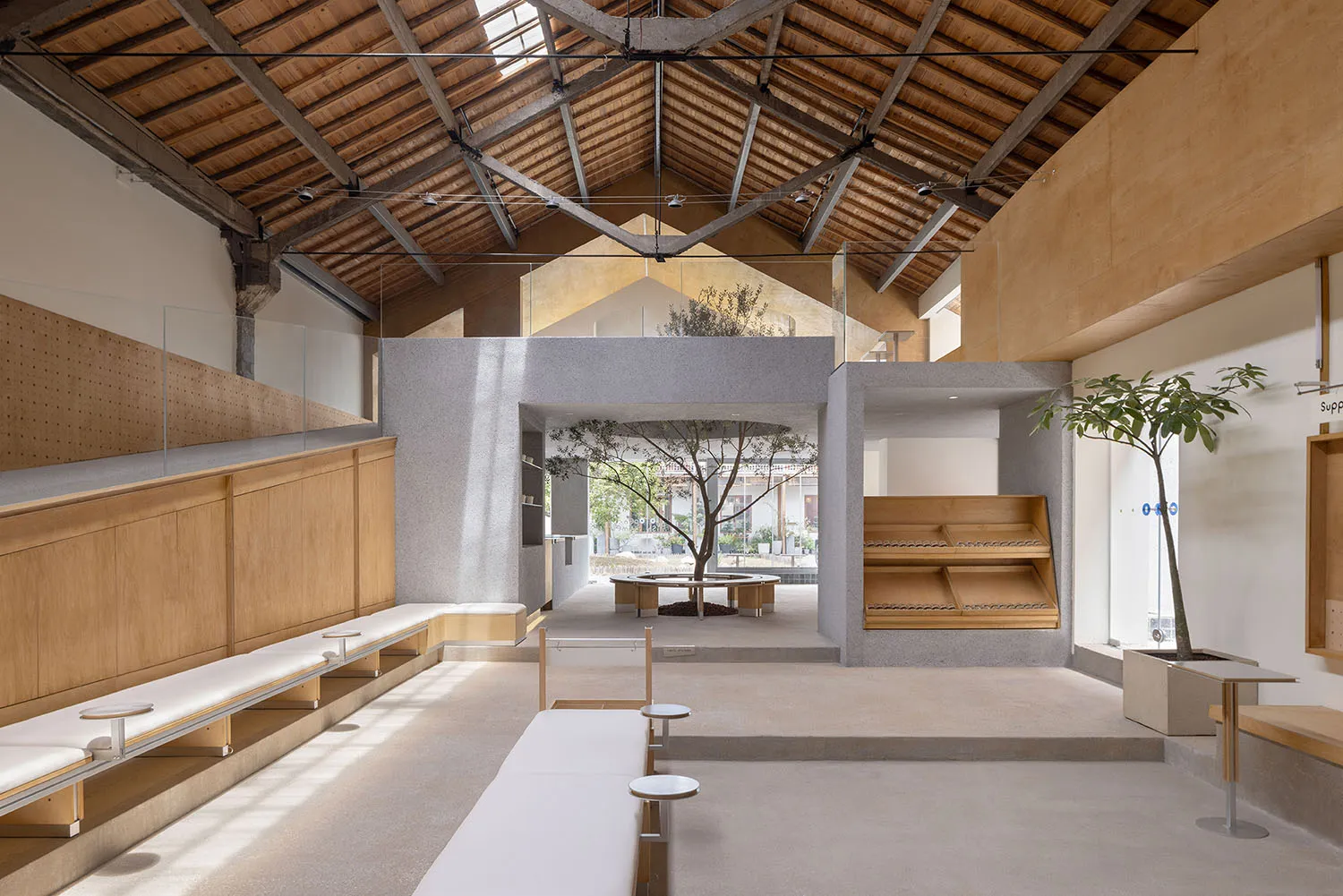A minimalist interior space featuring wooden finishes and open-plan design.