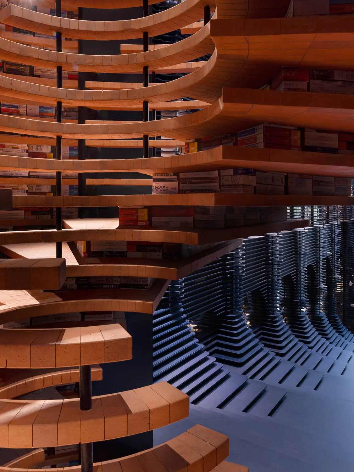 A library interior featuring cascading brick shelves and a wave-like structure.