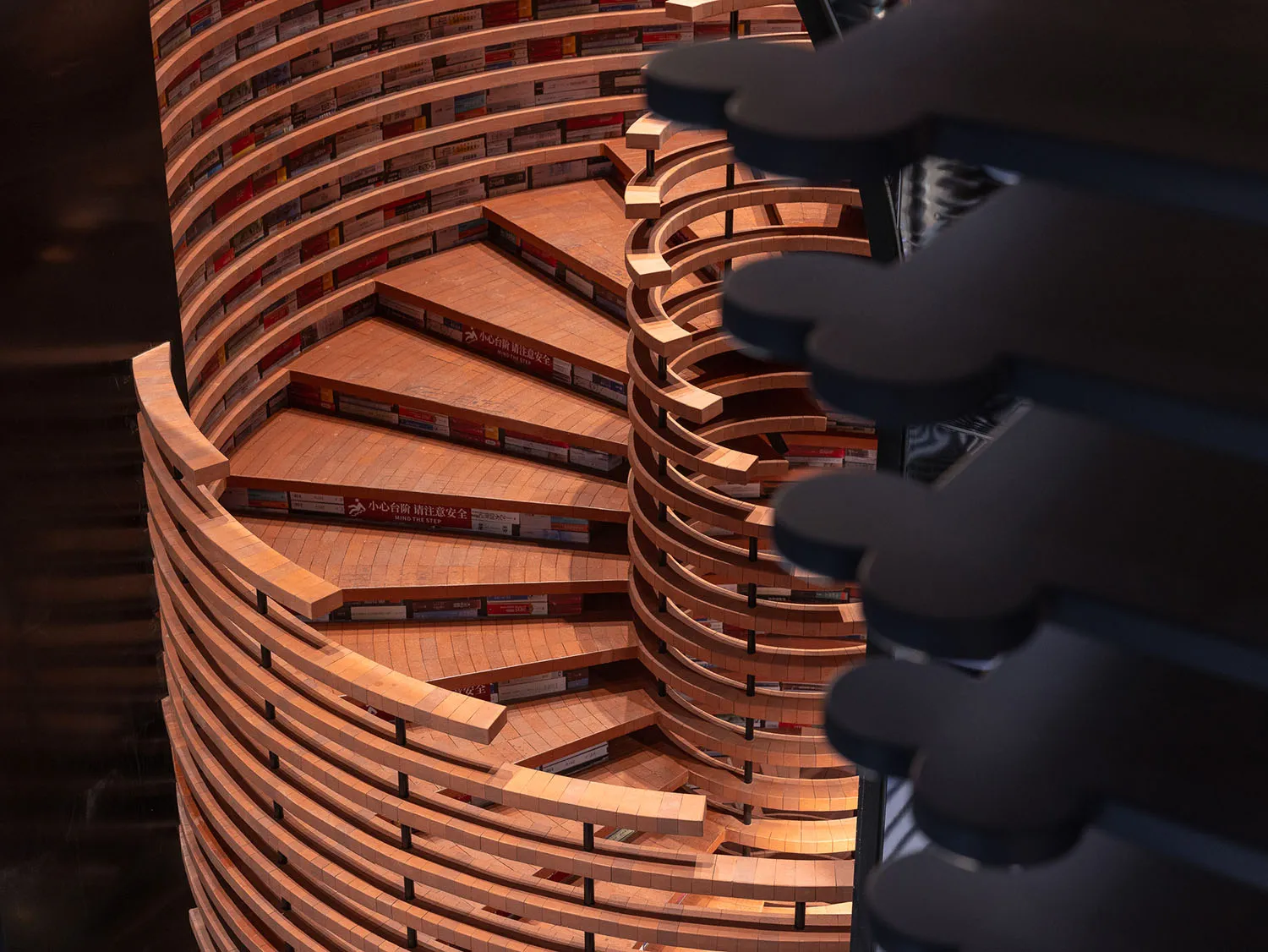 A spiraling staircase made of wood with multiple levels and railings.