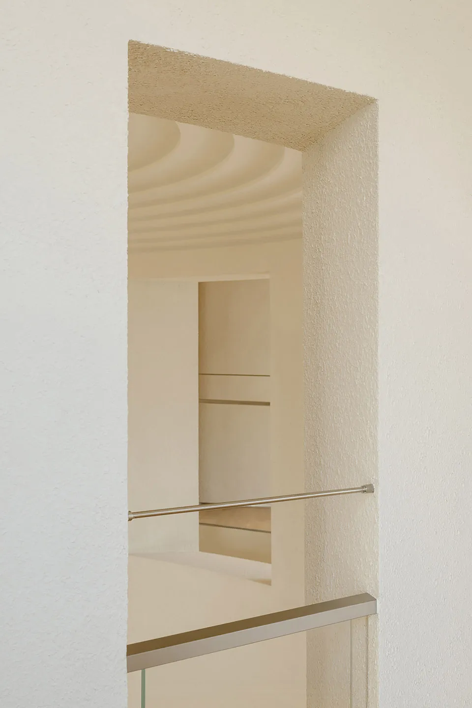 Modern minimalist interior space featuring glass elements