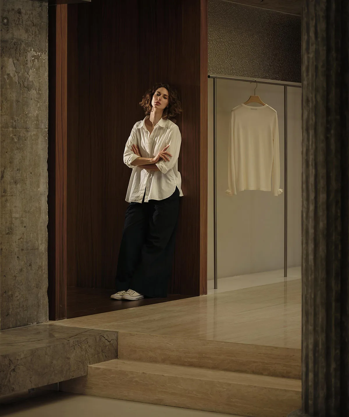 A photograph showcasing a modern minimalist interior with a concrete wall.