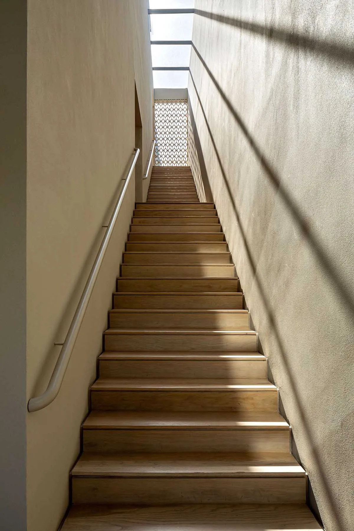 A modern wooden staircase with lighting features.
