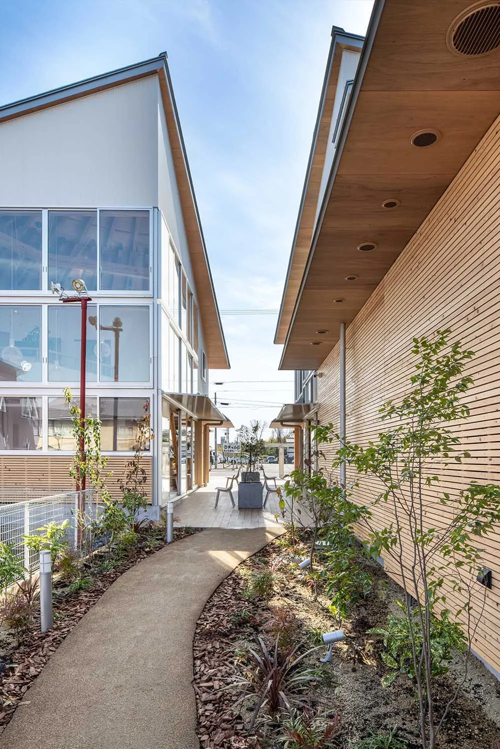 A minimalist commercial building with wooden accents, glass windows, and concrete elements.