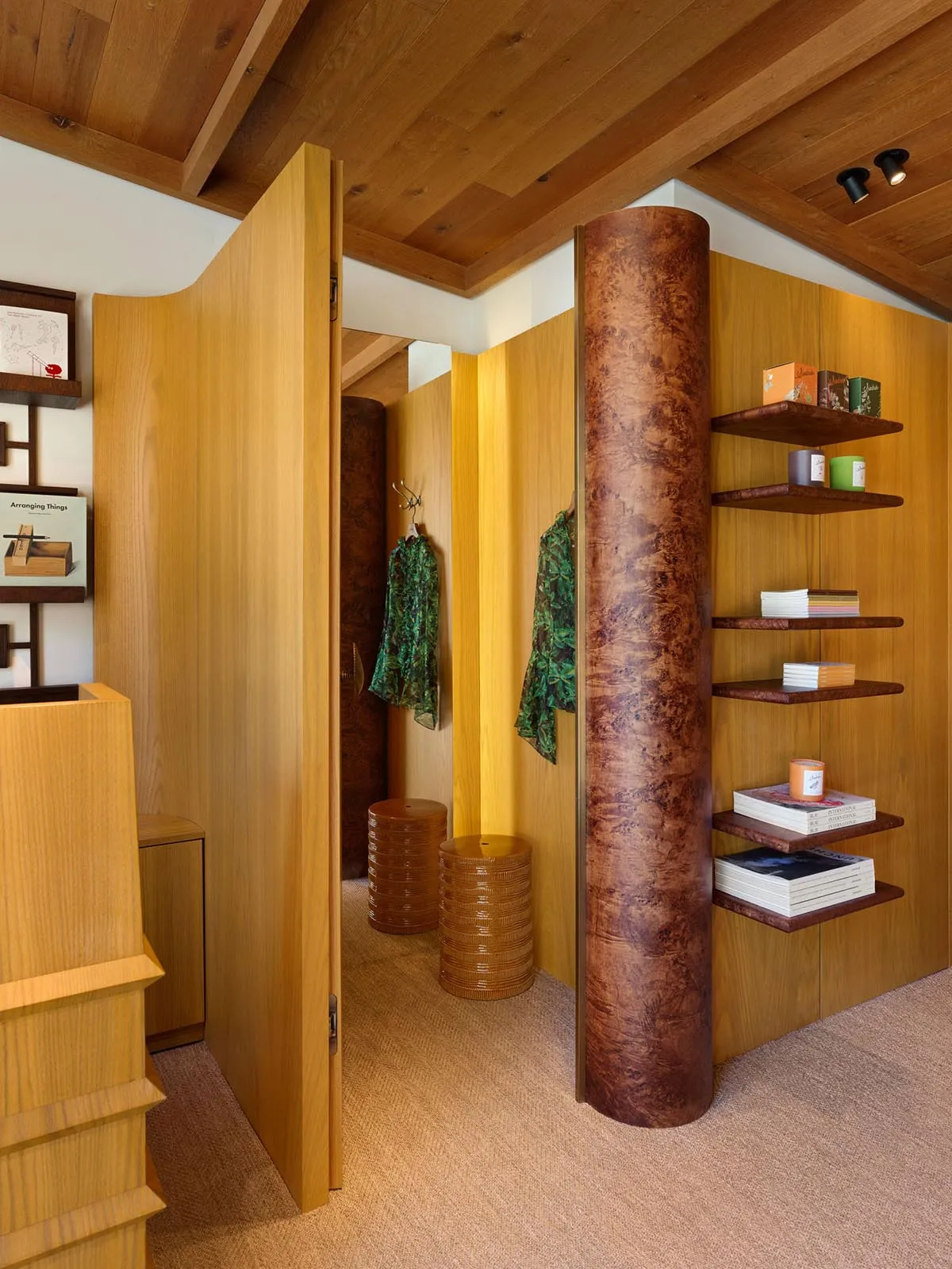 Modern clothing shop with wooden walls and clothing racks.