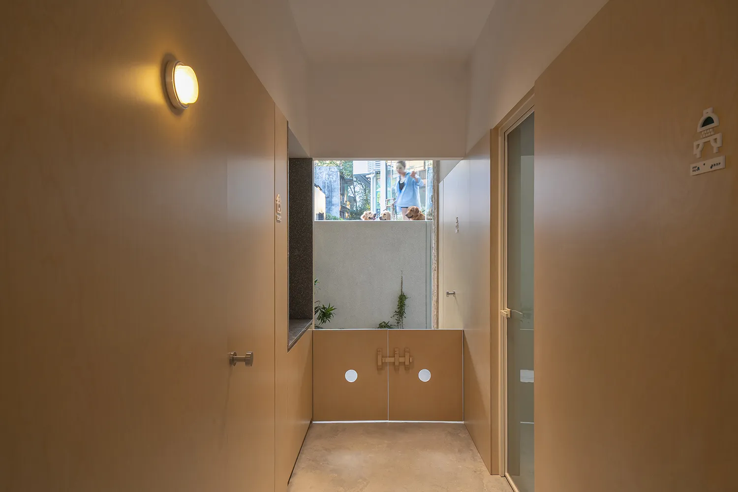 A minimalist hallway with wooden walls and white doors.