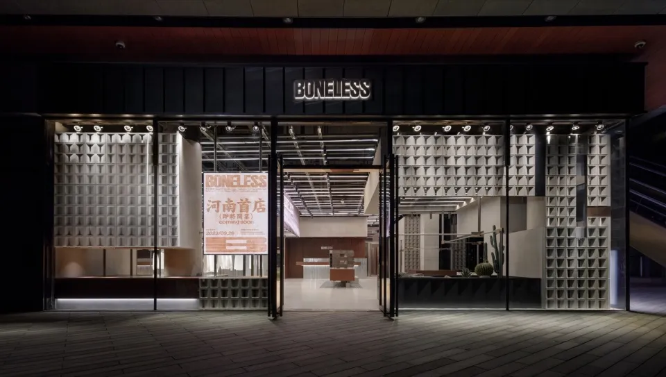 A modern commercial space with illuminated glass panels and industrial design elements.
