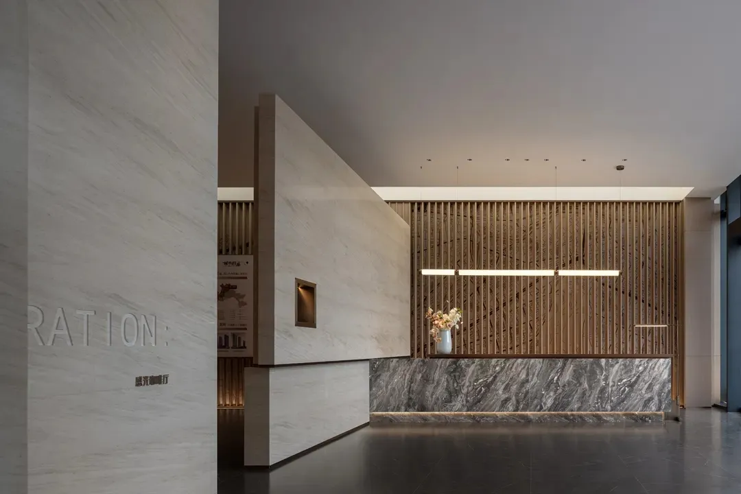 Modern lobby interior featuring marble and wood materials.
